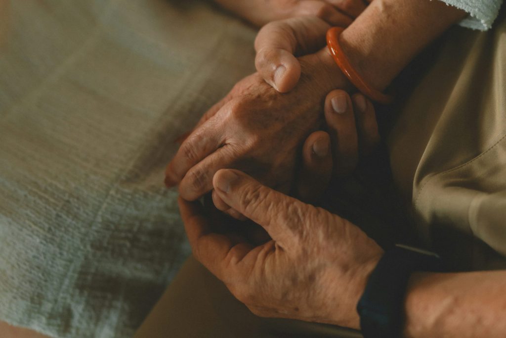 Two hands holding each other gently.